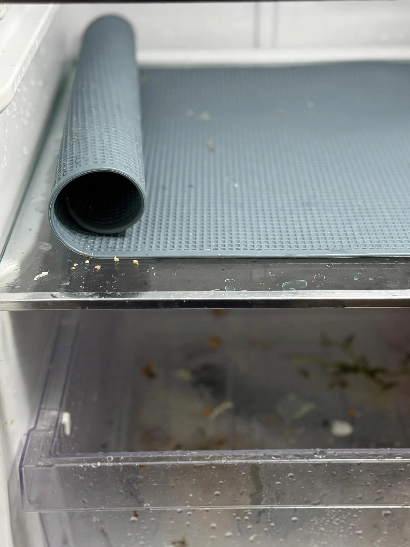Washable liner mat laid on a glass fridge shelf